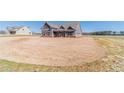 Charming exterior of a gray farmhouse-style home with a spacious yard and long driveway on a bright day at 1422 Alcovy Station Rd, Covington, GA 30014