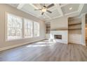 Bright living room with coffered ceiling, white brick fireplace, built-ins, and hardwood floors at 1434 Alcovy Station Rd, Covington, GA 30014