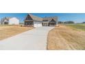 Well-designed house with a three-car garage and long drive on a spacious lot at 1452 Alcovy Station Rd, Covington, GA 30014