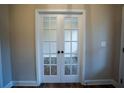 Elegant double glass doors with white frames, leading to another room with hardwood flooring at 37 Harmony Ridge Dr, Temple, GA 30179