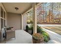 Front porch view showcasing a wooded area and a walkway at 7042 Confederate Ct, Villa Rica, GA 30116