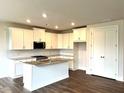 Bright kitchen featuring white cabinets, granite countertops, stainless steel appliances, and an island with a sink at 1059 Crest Mill Dr, Marietta, GA 30008