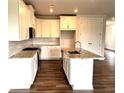 Bright kitchen with white cabinets, granite countertops, stainless steel appliances, and a center island with sink at 1059 Crest Mill Dr, Marietta, GA 30008