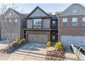Two-story townhome with stone and siding exterior, two-car garage, and landscaping at 2354 Attewood Dr, Buford, GA 30519