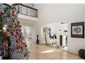 Elegant two-story entryway with marble floors, a grand staircase, and a decorated Christmas tree at 1055 Leadenhall St, Alpharetta, GA 30022