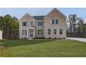 Two-story brick home with gray shutters and a landscaped lawn at 301 Delta Dr, Mcdonough, GA 30252