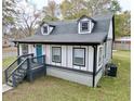 Charming two-story home showcasing black and white trim, a gabled roof, and a pop of color with a blue front door at 2933 5Th Sw St, Atlanta, GA 30315