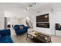 Open living area with blue velvet sofas, fireplace and large TV at 2933 5Th Sw St, Atlanta, GA 30315