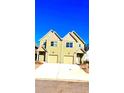 Two story townhome with neutral yellow siding, white trim, attached garage, and well-lit exterior at 3108-A Brownstone Se Ln, Atlanta, GA 30354