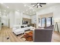 Open living room with light wood floors, sectional sofa, and marble accent wall at 1073 Mayson Turner Nw Rd, Atlanta, GA 30314