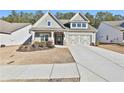 Gray house with stone accents and a 2-car garage at 590 Plainfield St, Fayetteville, GA 30215