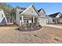 Gray house with stone accents and a 2-car garage at 590 Plainfield St, Fayetteville, GA 30215