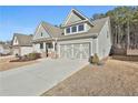 Gray house with stone accents and a 2-car garage at 590 Plainfield St, Fayetteville, GA 30215