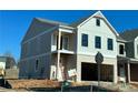 Two-story house with beige siding, brick bottom, and a two-car garage at 1074 Crest Mill Dr, Marietta, GA 30008