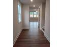 Inviting hallway with wood floors leading to a bright living area with large windows at 1074 Crest Mill Dr, Marietta, GA 30008