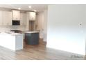 Contemporary kitchen with island and stainless appliances with new floors at 1074 Crest Mill Dr, Marietta, GA 30008
