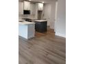 Modern kitchen featuring an island, stainless steel appliances, and beautiful hardwood floors at 1074 Crest Mill Dr, Marietta, GA 30008