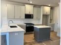 Bright kitchen featuring shaker cabinets, stainless steel appliances, and a center island at 1074 Crest Mill Dr, Marietta, GA 30008