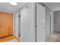 Bright hallway with wood floors, coat closet, and access to other rooms at 3501 Roswell Road Ne Rd # 110, Atlanta, GA 30305