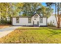 Beautiful home with a well-maintained lawn, modern black and white trim, and freshly landscaped yard at 358 Roy Sw St, Atlanta, GA 30310