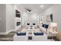 Staged living room with modern furniture, a fireplace, and neutral color palette at 358 Roy Sw St, Atlanta, GA 30310