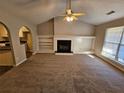 Neutral living room with a fireplace and built-in shelving at 6531 Gina Agha Cir, Lithonia, GA 30038