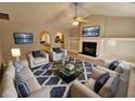 Cozy living room featuring plush seating, a fireplace, and a stylish blue patterned rug at 6531 Gina Agha Cir, Lithonia, GA 30038