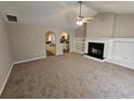 Bright living room with fireplace, ceiling fan, and convenient kitchen access at 6531 Gina Agha Cir, Lithonia, GA 30038