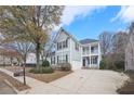 Two-story gray house with a two-car garage and a well-maintained lawn at 589 Lantern Wood Dr, Scottdale, GA 30079