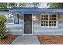 Close-up of the front door with a decorative metal security screen and painted blue trim at 2436 Clarissa Nw Dr, Atlanta, GA 30318