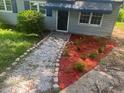Landscaped front yard with red mulch, white gravel, and stone edging around flower beds at 2436 Clarissa Nw Dr, Atlanta, GA 30318