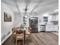 Modern dining area with a round wooden table and six chairs at 6881 Hickory Hollow Dr, Douglasville, GA 30135