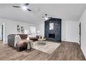 Spacious living room featuring a modern fireplace and L-shaped sectional sofa at 6881 Hickory Hollow Dr, Douglasville, GA 30135