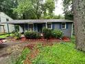 Charming single-story home featuring blue shutters and lush landscaping at 3530 Fairlane Nw Dr, Atlanta, GA 30331