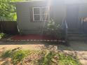 Gray home with window and door, surrounded by flower bed and patchy grass at 501 Aberdeen Nw Dr, Atlanta, GA 30318
