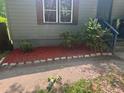 Close up of front yard with gray siding, red mulch, and small bushes at 501 Aberdeen Nw Dr, Atlanta, GA 30318