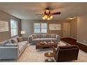Spacious living room featuring plush sofas, a coffee table, and large windows at 5090 Great Meadows Rd, Lithonia, GA 30038