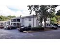 Apartment building featuring balconies, stone accents, and a well-maintained exterior surrounded by lush greenery at 1150 Collier Nw Rd # 4B, Atlanta, GA 30318