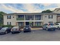 Apartment building with balconies, stone accents, and ample parking space for residents and visitors at 1150 Collier Nw Rd # 4B, Atlanta, GA 30318