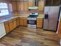 Kitchen with stainless steel appliances and wood flooring at 1593 Cherry Hill Ln, Conyers, GA 30094