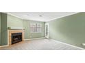 Comfortable living room features neutral carpet, fresh paint, and a cozy fireplace at 511 Barrington Hills Dr, Atlanta, GA 30350