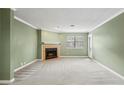 Comfortable living room with neutral carpet, fresh paint, and a cozy fireplace at 511 Barrington Hills Dr, Atlanta, GA 30350