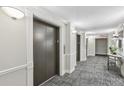 Building hallway with elevators and carpet at 795 Hammond Dr # 401, Atlanta, GA 30328