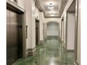 Clean hallway with marble floors and elevators at 795 Hammond Dr # 401, Atlanta, GA 30328