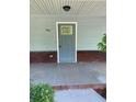 Close-up of the house number on a light blue front door with brick accents and a concrete porch at 2467 Shady Grove Rd, Carrollton, GA 30116