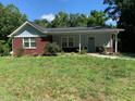 Charming bungalow with brick accents and a walkway leading to the front door, nestled in a lush, green yard at 2467 Shady Grove Rd, Carrollton, GA 30116