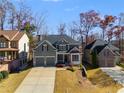 Charming traditional home featuring a two-car garage, gray siding, and well-maintained landscaping at 243 Yorkshire Ln, Villa Rica, GA 30180