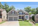 Charming home featuring a well-manicured lawn, stone accents, and a two-car garage at 243 Yorkshire Ln, Villa Rica, GA 30180