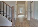 Bright entry hall with hardwood floors, elegant staircase, and neutral color palette at 4045 Andover Cir, Mcdonough, GA 30252