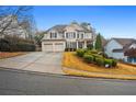 Brick two-story house with a three-car garage and nicely landscaped yard at 204 Gold Valley Xing, Canton, GA 30114